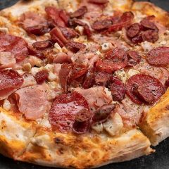 pngtree-meat-galore-pizza-showcased-on-a-sleek-concrete-background-photo-image_40472892